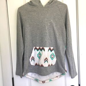 Grey sweater with designs.